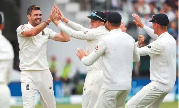  ?? AFP ?? England’s James Anderson (left) celebrates with teammates after dismissing India’s Murali Vijay, his 100th Test wicket at Lord’s on the fourth day of the second Test yesterday.