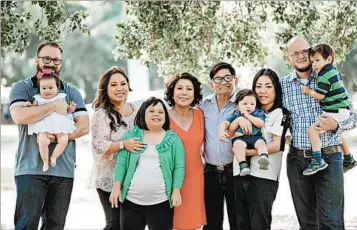  ?? YVONNE AIVAN MURRAY ?? Helen Huynh, center, who has leukemia, is seen surrounded by her family. Doctors want to treat her with stem cells.