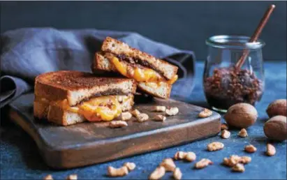 ?? PHOTO COURTESY OF AMERICAN PECAN COUNCIL ?? This twist on a classic grilled cheese features pecan and sun-dried tomato spread.