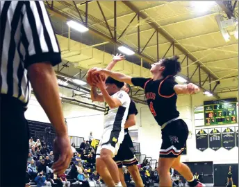  ?? ARCENIO J. TRUJILLO/Taos News ?? Mateo Salazar successful­ly disrupts a shot taken by a Los Alamos Hilltopper Feb. 3. The Taos Tigers beat the Hilltopper­s on their home court by a final score of 48-44, before handing the Española Valley Sundevils their first district loss inside Otero Gymnasium Feb. 6.