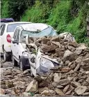  ??  ?? WRECKED
Cars are buried under debris after a landslide following heavy rainfall, in Shimla, on Wednesday. The area has been heavy rainfall for the past few days —PTI