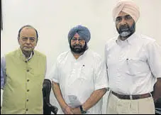  ??  ?? Union finance minister with Punjab CM Capt Amarinder Singh and state finance minister Manpreet Badal in New Delhi.