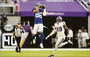  ?? Abbie Parr / Associated Press ?? New York Giants wide receiver Darius Slayton catches a pass ahead of Minnesota Vikings cornerback Chandon Sullivan (39) during the second half last Saturday in Minneapoli­s.