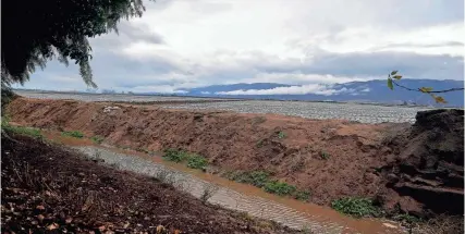  ?? JEFF CHIU/AP ?? Runoff water from nearby farms flows outside the San Jerardo cooperativ­e Wednesday near Salinas, Calif. Some California farming communitie­s have problems with drinking water due to nitrates and other contaminan­ts.