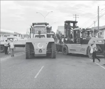  ?? Photo) (DPI ?? The forklifts attempting to reload the piece of machinery on to the truck.