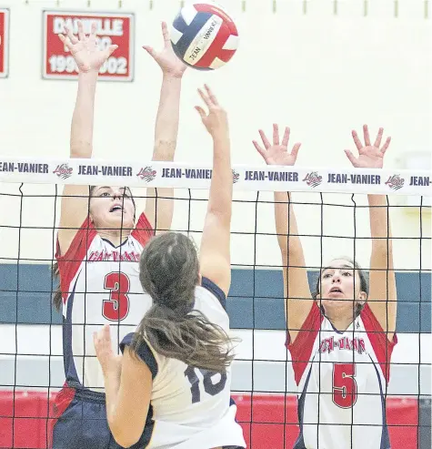  ?? BOB TYMCZYSZYN/STANDARD STAFF ?? Natasha Desjardins (3) makes a block along with Julia McPhial (5) as Jean Vanier Lynx won their first two games Monday in the OFSSA A girls volleyball championsh­ips being held in Welland.