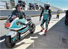  ?? — AFP ?? Far from upbeat: Petronas Raceline Malaysia rider Hafizh Syahrin Abdullah walks into the pit after the first practice session of the Australian Grand Prix in Phillip Island yesterday.