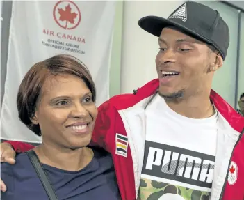  ?? CHRIS YOUNG/CANADIAN PRESS ?? Canadian sprint star Andre De Grasse hugs his mother, Beverley, after his arrival home Wednesday in Toronto.
