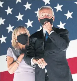  ?? OLIVIER DOULIERY AFP VIA GETTY IMAGES ?? Former vice-president and Democratic presidenti­al nominee Joe Biden, with his wife, Jill Biden, wear masks at the conclusion of the DNC.