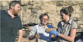  ?? Picture / AAP ?? Researcher­s (from left) Chris Clarkson, Richard Fullagar and Elspeth Hayes examine a grindstone from the lowest layers of the excavation site at the Madjedbebe rock shelter in the Kakadu National Park.