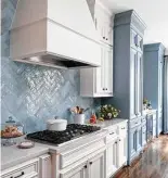  ??  ?? A smaller range hood and pretty backsplash tile made the kitchen range more functional.