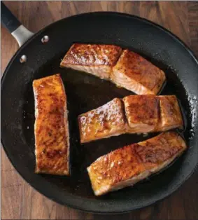  ?? STEVE KLISE/AMERICA’S TEST KITCHEN—ASSOCIATED PRESS ?? This undated photo provided by America’s Test Kitchen in October 2018shows honeylime glazed roast salmon in Brookline, Mass. This recipe appears in the cookbook “How to Roast Everything.”