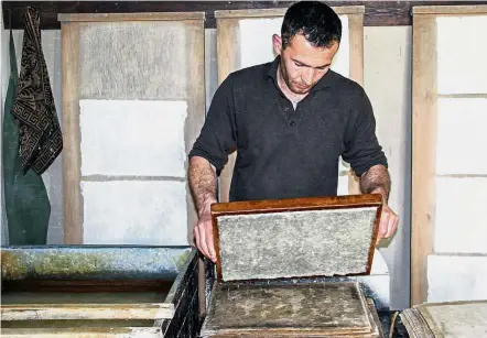  ?? — AFP ?? Ancient art: A worker in the process of making paper at Mukhtarov’s paper mill in Koni Ghil, outside Samarkand.