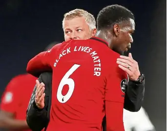  ??  ?? My hero’s back: Ole Gunnar Solskjaer hugging Paul Pogba after the match which saw united holding Spurs to a 1-1 draw. — aFP