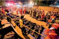  ??  ?? Rescue workers gather bags containing dead bodies of victims of an explosion at a night market in Davao City in southern island of Mindanao early September 3, 2016 (AFP)