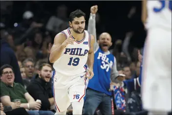  ?? MATT SLOCUM — THE ASSOCIATED PRESS ?? Raul Neto, pointing to a teammate after making a 3-pointer against the Charlotte Hornets Sunday, has been a solid understudy at point guard for the 76ers.