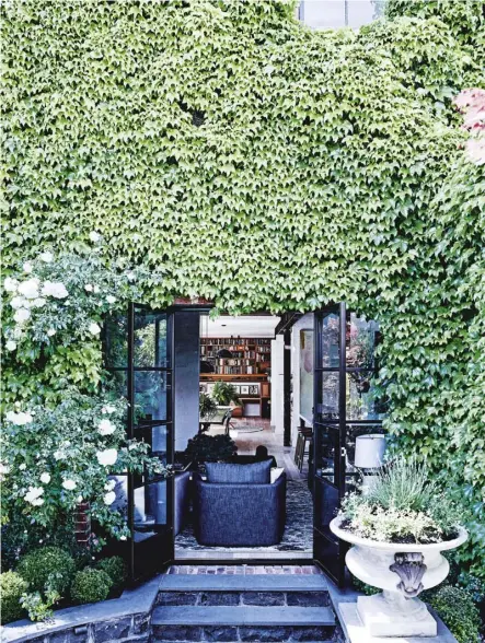  ??  ?? this page: the garden by FRANKLIN LANDSCAPE & DESIGN makes the most of the ivy that covered the house when the owners first saw it; bluestone paving from BEAUMONT TILES. opposite page: in the main living room, ‘Cleo’ sofa by JARDAN; custom-made...