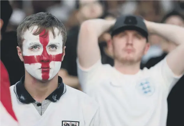  ??  ?? 0 England fans in Manchester are left stunned and heartbroke­n after watching their team lose the World Cup semi-final when Croatia came from behind to win 2-1