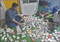  ??  ?? Health workers sort medicine in their boat hospital at Banishanta.