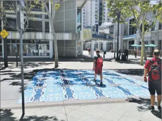  ?? SAL PIZARRO/ STAFF ?? A crosswalk, designed by artist Corinne Okada Takara, decorates downtown San Jose on Paseo de San Antonio, with touches inspired by the Guadalupe River, the former Chinatown and Silicon Valley.