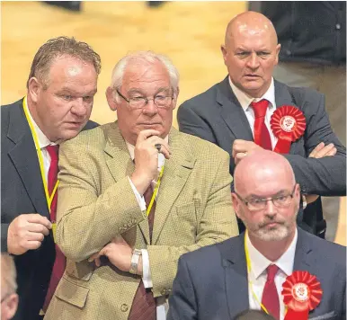  ??  ?? Fife provost and Labour councillor Jim Leishman and party colleagues look grim-faced as the results come in at Rothes Halls yesterday. Mr Leishman was re-elected in Dunfermlin­e Central.