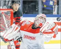  ?? AP PHOTO ?? Canada’s Pierre-Luc Dubois watches Denmark’s Sebastian Dahm make a save during world hockey championsh­ip action Monday in Herning, Denmark.