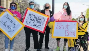  ?? PHOTO: LUISA GIRAO ?? Sign of the times . . . Kind Women Charitable Trust members (from left) Sarah McCartney, Rebecca Amundsen, Labour Party MP Liz Craig, Sharon Reece, and Sheree Carey take part in an ‘‘antianti’’ vaccinatio­n protest.