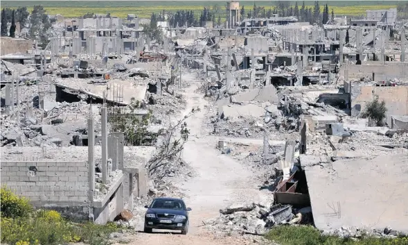  ?? MEHMET SHAKIR/ THE ASSOCIATED PRESS ?? The Kurdish town of Kobani on the Turkish-Syrian border lies in ruins, its streets littered with unexploded ordnance months after it was liberated from ISIL.