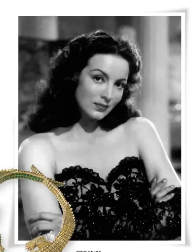  ??  ?? EPIC MUSE Mexican screen icon María Félix and the custom Crocodile necklace Cartier made for her in 1975. This lifelike piece has on one crocodile over 60 carats of brilliant-cut fancy intense yellow diamonds and navette-shaped emerald cabochons for the eyes, while the other has over 66 carats of emeralds and ruby cabochons for the eyes