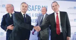  ?? — Reuters ?? Safran CEO Philippe Petitcolin (2nd L) Shakes hands with Zodiac Aerospace CEO Olivier Zarrouati at the end of a press conference in Paris o