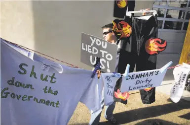  ?? Michael Macor / The Chronicle 2017 ?? Michelle Park of Turlock protests before a “coffee with constituen­ts” held by Rep. Jeff Denham, R-Turlock, in Riverbank (Stanislaus County) in 2017. More women have taken roles in politics in the area.