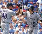  ?? NAM Y. HUH/ASSOCIATED PRESS ?? Colorado’s Ryan Hanigan, right, celebrates with German Marquez after hitting a two-run homer against the Cubs on Friday afternoon.