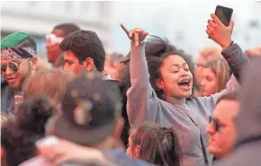  ?? CHRIS KOHLEY / MILWAUKEE JOURNAL SENTINEL ?? Concertgoe­rs dance at the new U.S. Cellular Connection Stage before a stage-warming concert featuring Diplo on Friday. For more photos, go to