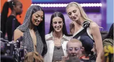  ?? ADAM HUNGER THE ASSOCIATED PRESS ?? From left, LSU’s Angel Reese (No. 7 by Chicago Sky), Iowa’s Caitlyn Clark (No. 1 by Indiana Fever) and Stanford’s Cameron Brink (No. 2 by Los Angeles Sparks) were all selected early at the WNBA draft Monday night in New York.