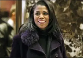  ?? SETH WENIG — THE ASSOCIATED PRESS Photos and text from wire services ?? In this file photo, Omarosa Manigault smiles at reporters as she walks through the lobby of Trump Tower in New York.