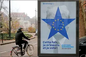 ?? REUTERS ?? A poster overlaid with a star-shaped yellow and blue European Union flag with the likeness of American President Donald Trump to encourage voter registrati­on for the upcoming 2019 European Elections is seen in Strasbourg, France, on Friday. The slogan reads “This time I will register and I will vote”.