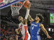  ?? ALAN YOUNGBLOOD / ASSOCIATED PRESS ?? Florida guard Scottie Lewis (23) shoots against Kentucky forward Nick Richards during the first half Saturday in Gainesvill­e, Florida.