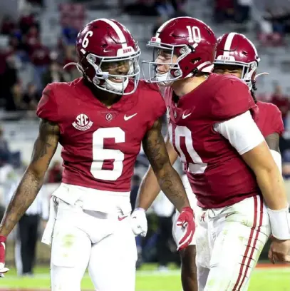  ?? Associated Press ?? If Alabama wide receiver DeVonta Smith, left, becomes the first wide receiver to win the Heisman since 1991, the first person he can thank will be his quarterbac­k, Mac Jones, another finalist for the trophy.