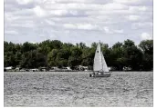  ?? CHRIS STEWART / STAFF 2015 ?? A sailboat glides by on Grand Lake St. Marys in Auglaize County. An algae advisory has been issued for the lake this summer.