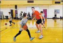  ?? K.M. Cannon ?? Las Vegas Review-journal @Kmcannonph­oto Portland Trail Blazers center Zach Collins runs a drill with Luke Yurik, 14, during camp at Bill & Lillie Heinrich YMCA.