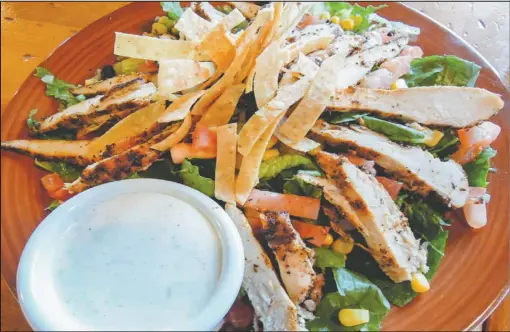  ??  ?? Colton’s offers a Southwest Chicken Salad (right), blackened chicken strips served on fresh mixed greens, diced tomatoes and black bean corn salsa, topped with tortilla chips and ranch dressing.