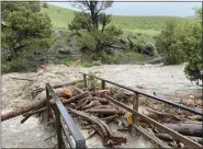  ?? AP FILE VIA NATIONAL PARK SERVICE ?? A washed out bridge from flooding is seen at Rescue Creek in Yellowston­e National Park, Mont., on June 13 .