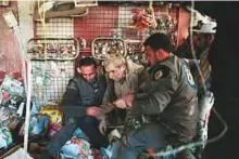  ?? AFP ?? Civilian volunteers, known as the White Helmets, rescue a survivor following air strikes on the rebel-held town of Hamouria outside Damascus yesterday.