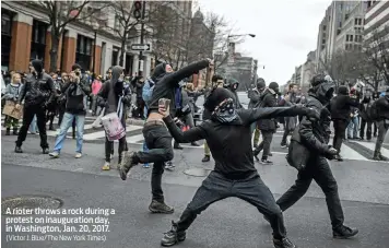  ?? (Victor J. Blue/The New York Times) ?? A rioter throws a rock during a protest on inaugurati­on day, in Washington, Jan. 20, 2017.