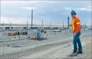  ?? NEWS PHOTO COLLIN GALLANT ?? Mason surveys the data processing facility. The 10-acre facility was fully operationa­l within 90 days of signing a major power purchase agreement with the City of Medicine Hat.