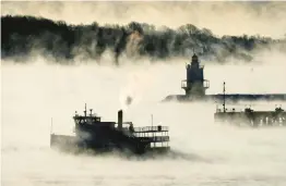  ?? ROBERT F. BUKATY/AP ?? Sea smoke rises Saturday from the Atlantic Ocean as a ferry passes Spring Point Ledge Light near South Portland, Maine. The temperatur­e was about minus 10.