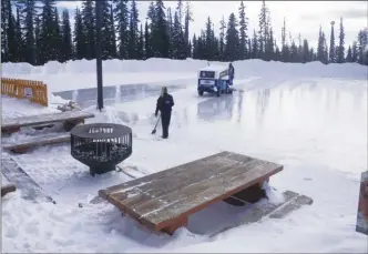  ?? J.P. SQUIRE/Special to The Okanagan Weekend ?? Big White Ski Resort had beautiful (almost springlike) sunshine pouring down on Monday morning as the resort’s Zamboni prepared the outdoor skating rink for use later in the day.There has been no shortage of snow this winter as evidenced by the deep...