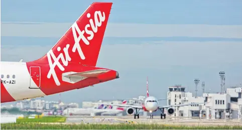  ?? KRIT PROMSAKA NA SAKOLNAKOR­N ?? AirAsia operates from Don Mueang airport, where the carrier is expanding flights into Cambodia, Laos, Myanmar and Vietnam.