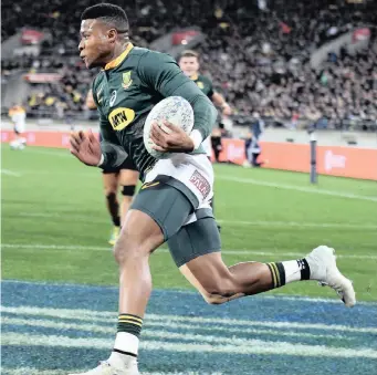  ??  ?? South Africa’s Aphiwe Dyantyi goes over for one of his two tries during the Rugby Championsh­ip Test against the All Blacks in Wellington earlier this season, which the Springboks won by two points | EPA