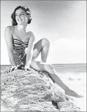  ?? Photograph from Kathy Zuckerman ?? A TEENAGE Kathy Kohner Zuckerman relaxes on the beach, circa 1957. Her father turned her surfing tales into a novel, “Gidget,” which then became a film.